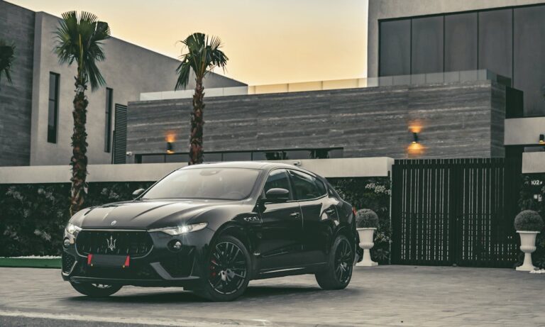 The Art of Drawing Readers In: Your attractive post title goes here Elegant black Maserati sports car parked in front of a contemporary home at dusk.