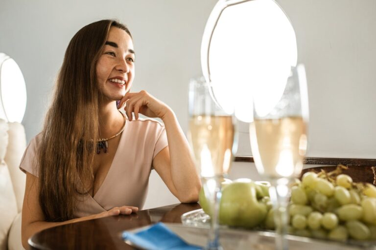 Mastering the First Impression: Your intriguing post title goes here Woman relaxing in a private jet with champagne and fresh fruit, epitomizing luxury travel.